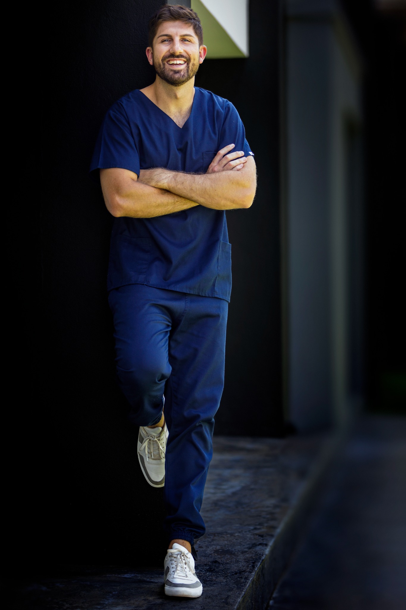 Dr Luhard in navy medical scrubs